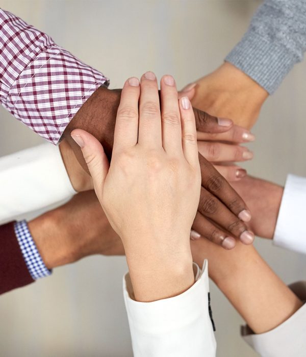 business-team-with-hands-on-top-at-office-PTCEYXU.jpg